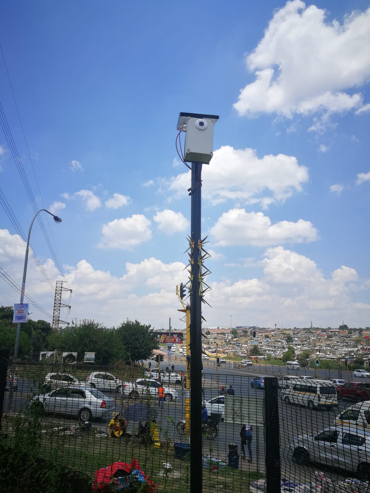 Anti-vandal security camera pole overlooking a public area